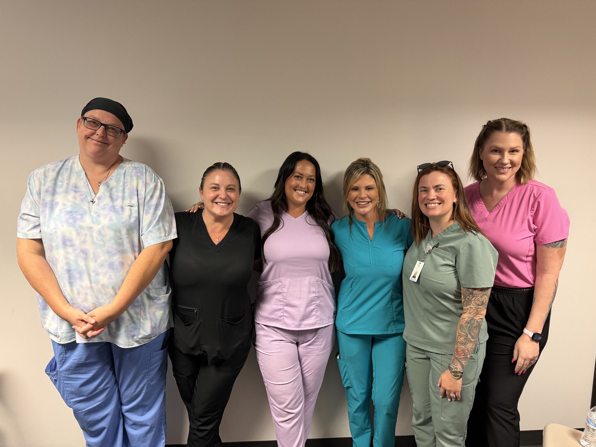 Six Access Home Health nurses in scrubs