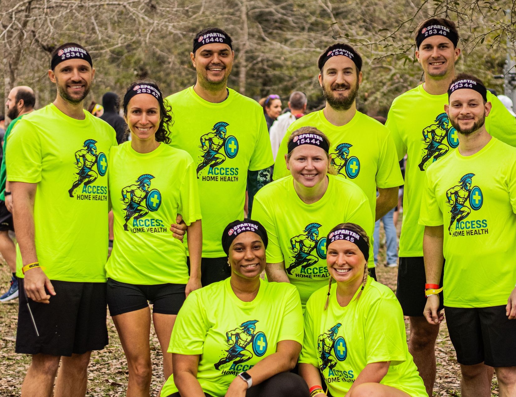The Access Home Health team in matching team shirts at a Spartan obstacle race