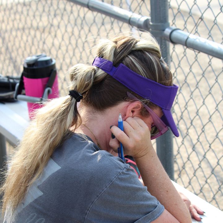 Kelly working through a lineup with a pen on the bleachers