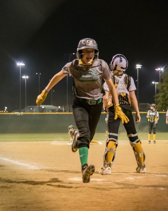 A player sprinting home under the lights