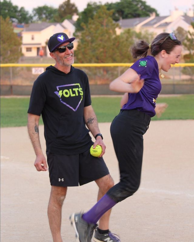 Kelly and Jeff celebrating on the infield after a win