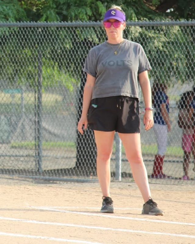 Kelly coaching the base line in a Volts shirt
