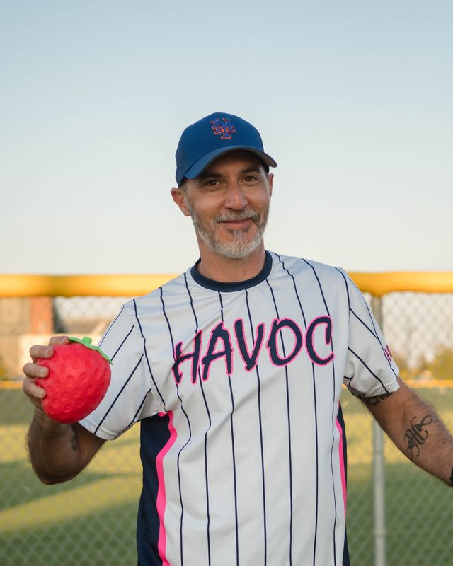 Jeff in a Havoc jersey holding a strawberry cooler
