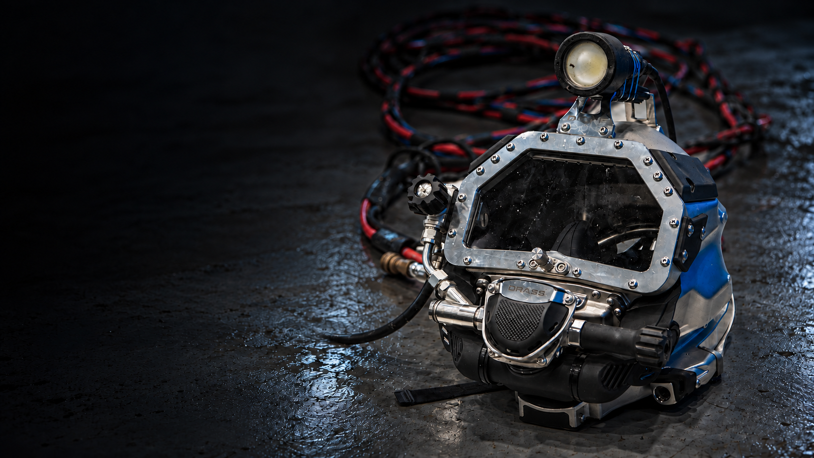 DRASS D-ONE diving helmet with light and umbilical on a workshop floor