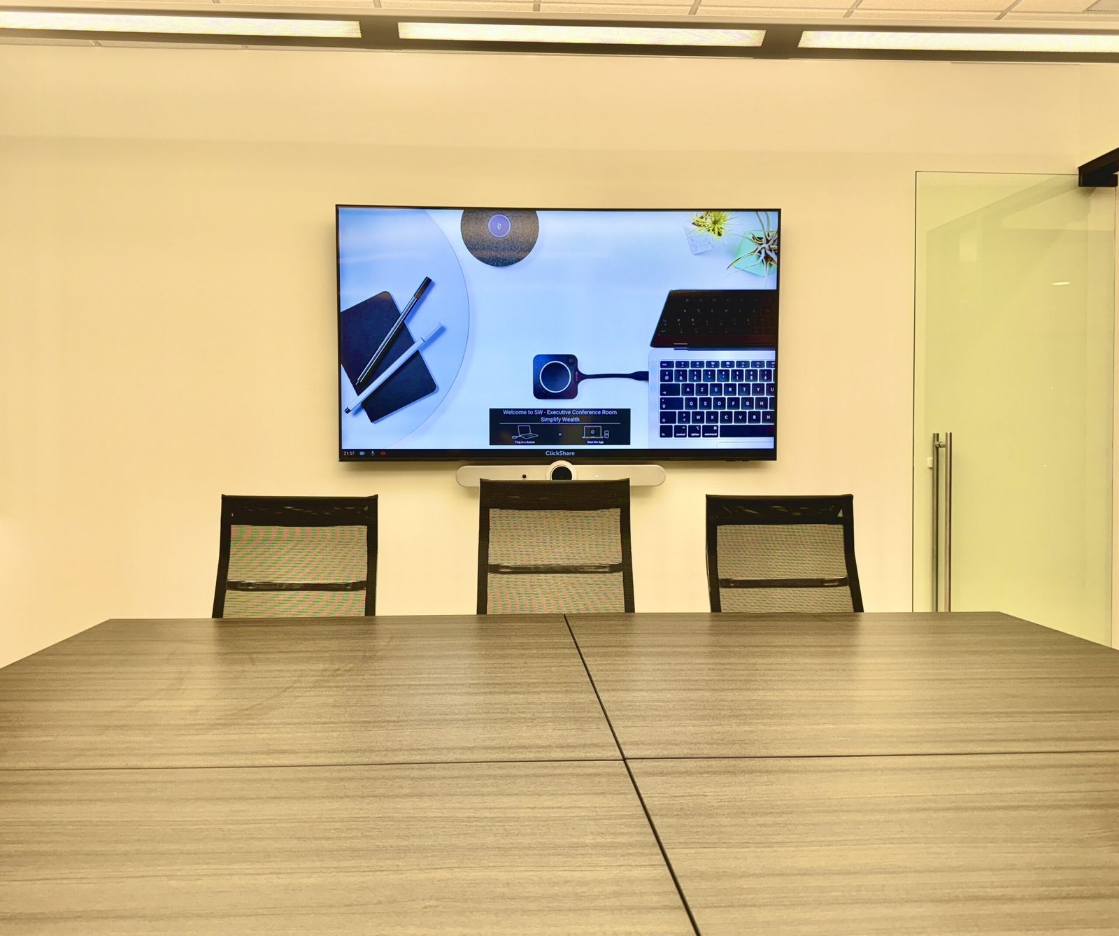 Video conferencing system installed above a conference room table