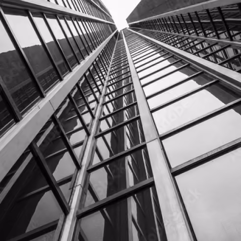 family office Miami high-rise building with a reflective glass facade looking up from below