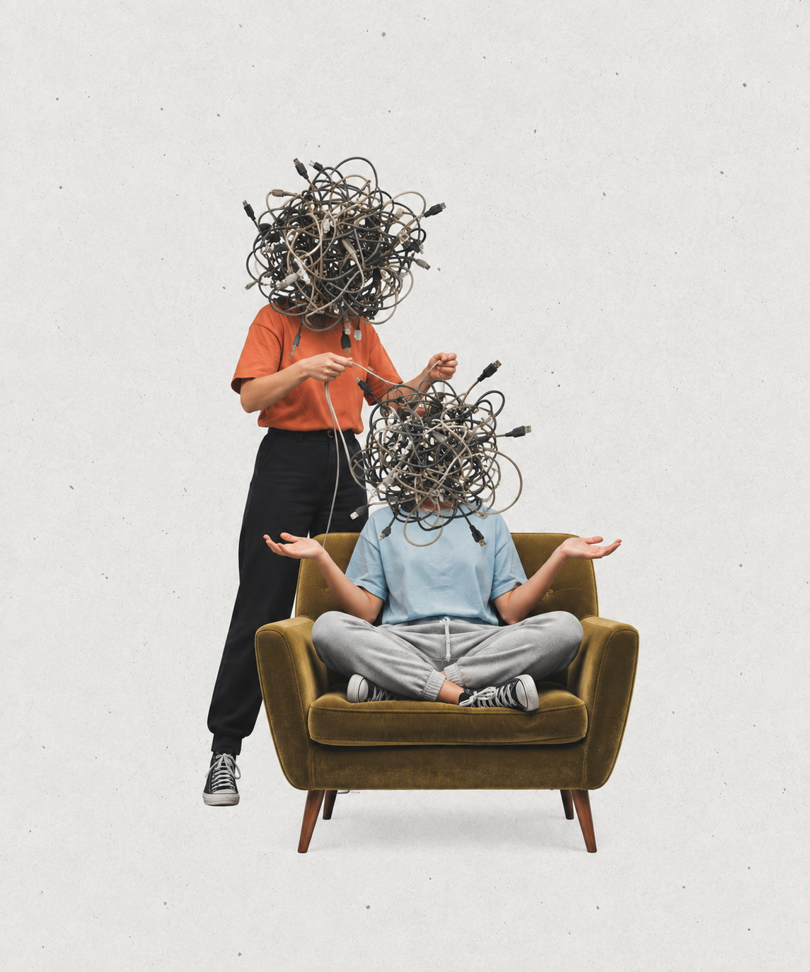 Two people with tangled cable heads around a retro armchair