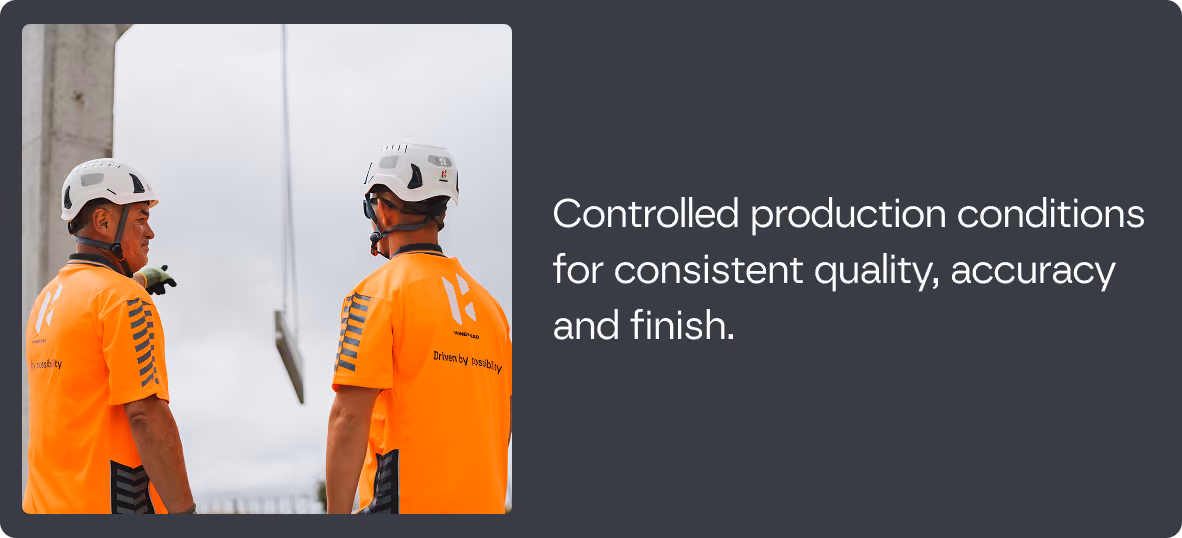 Two workers wearing white safety helmets and orange shirts with 'Driven by reliability' on the back, standing side by side, with text to the right reading 'Controlled production conditions for consistent quality, accuracy and finish.'