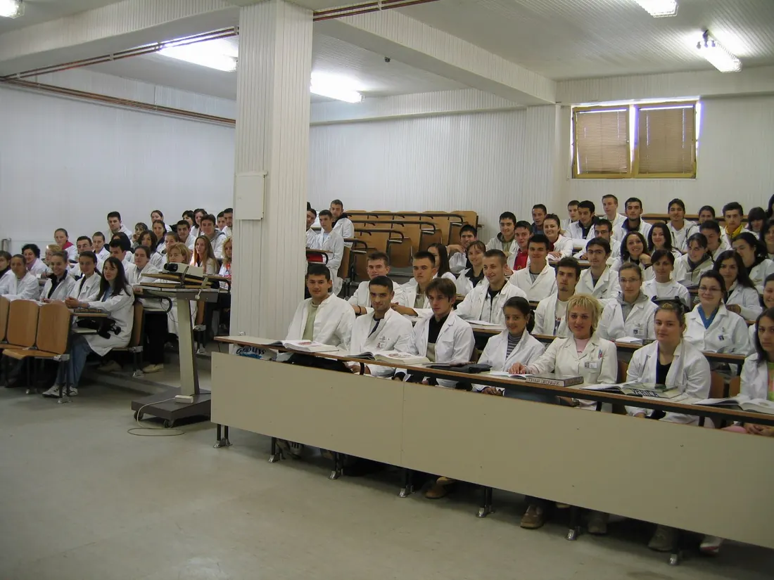 Students in white coats in a lecture hall at the Faculty of Medicine in Foča