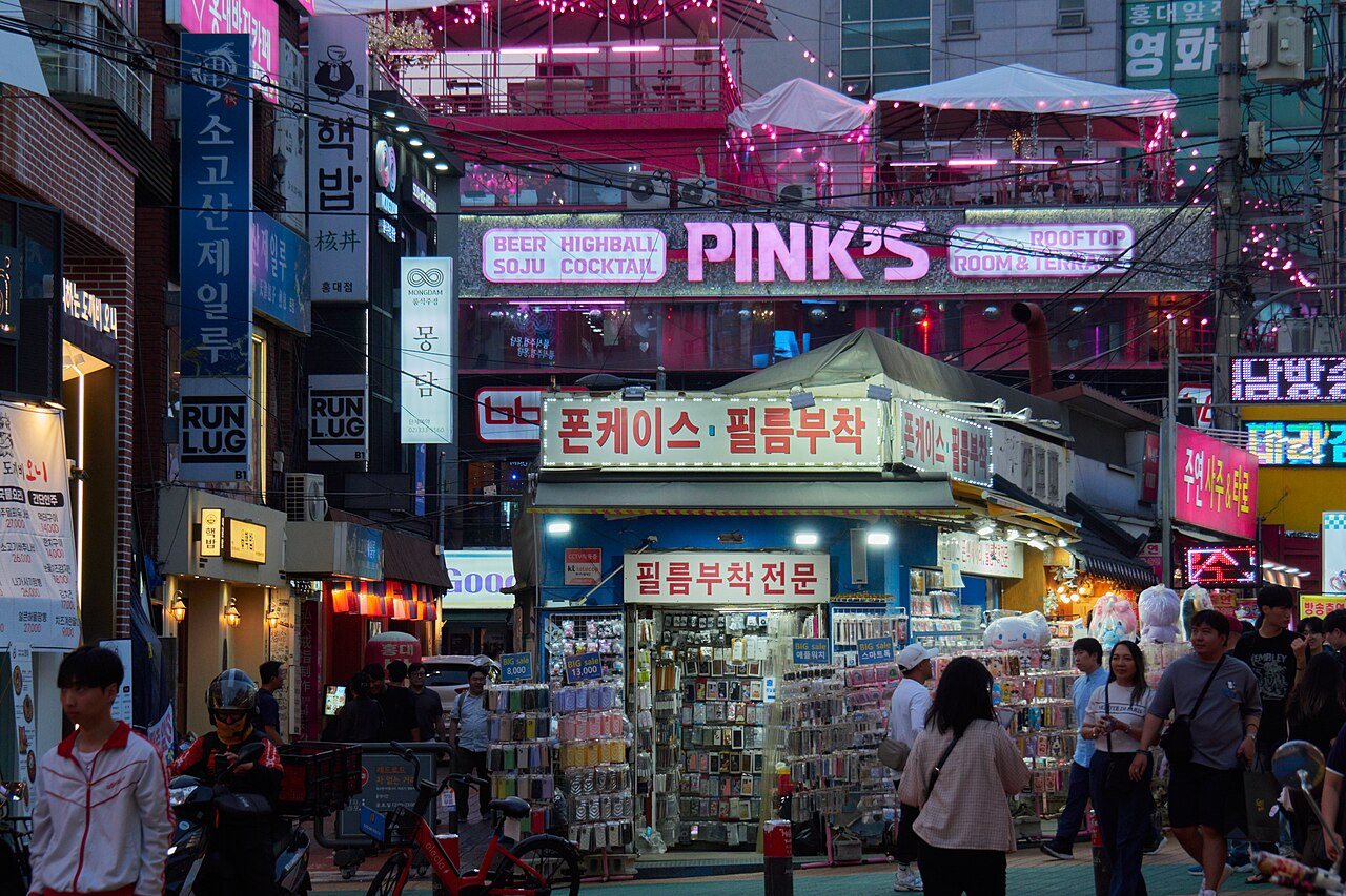 A Hongdae street with shops and pedestrians; archival context photograph made before 16 September 2024.