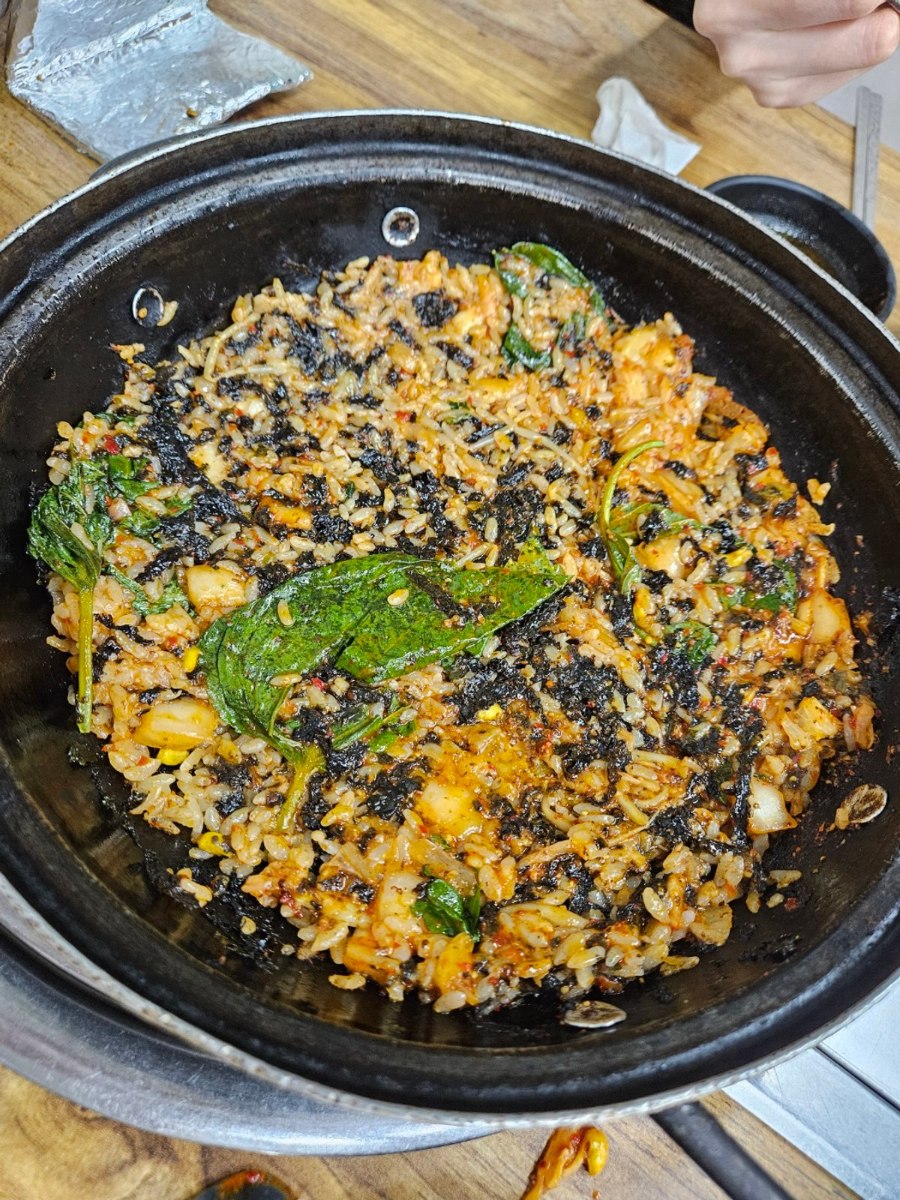 Fried rice with perilla leaves and seaweed in a black pan at Hannamdong Gamjatang, 2023.