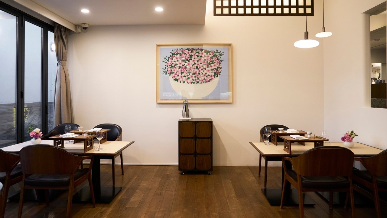 Individual raised wooden settings on tables in Kwonsooksoo’s dining room.
