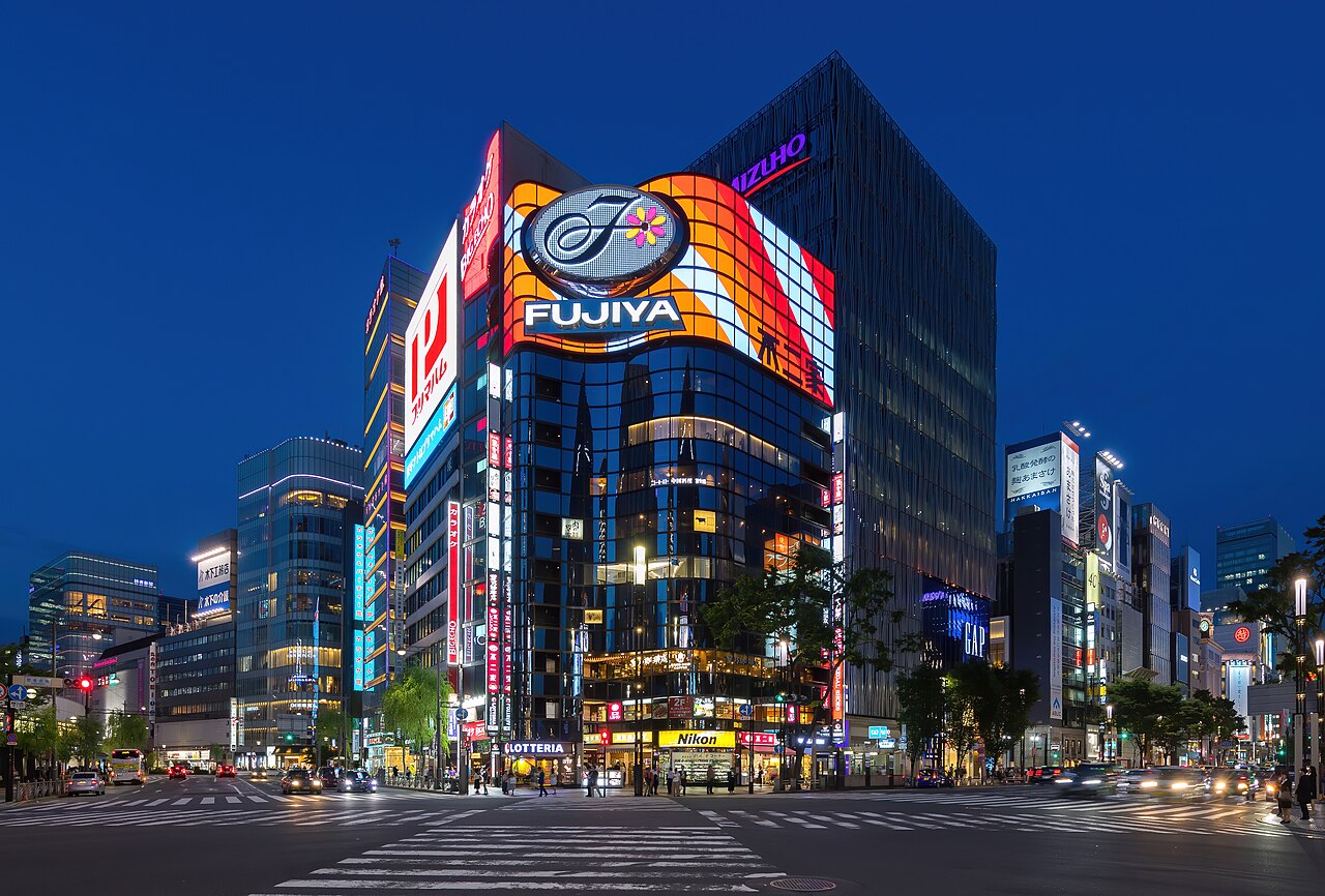The illuminated Fujiya building at a Ginza street corner in June 2019, included as neighborhood context and not as an image of Sawada.