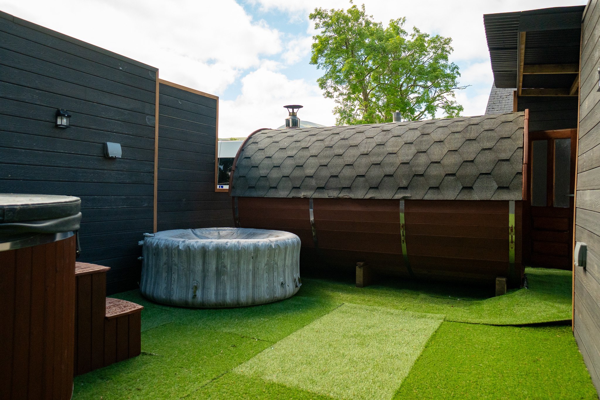 The two hot tubs and barrel sauna in the grounds at The Briers