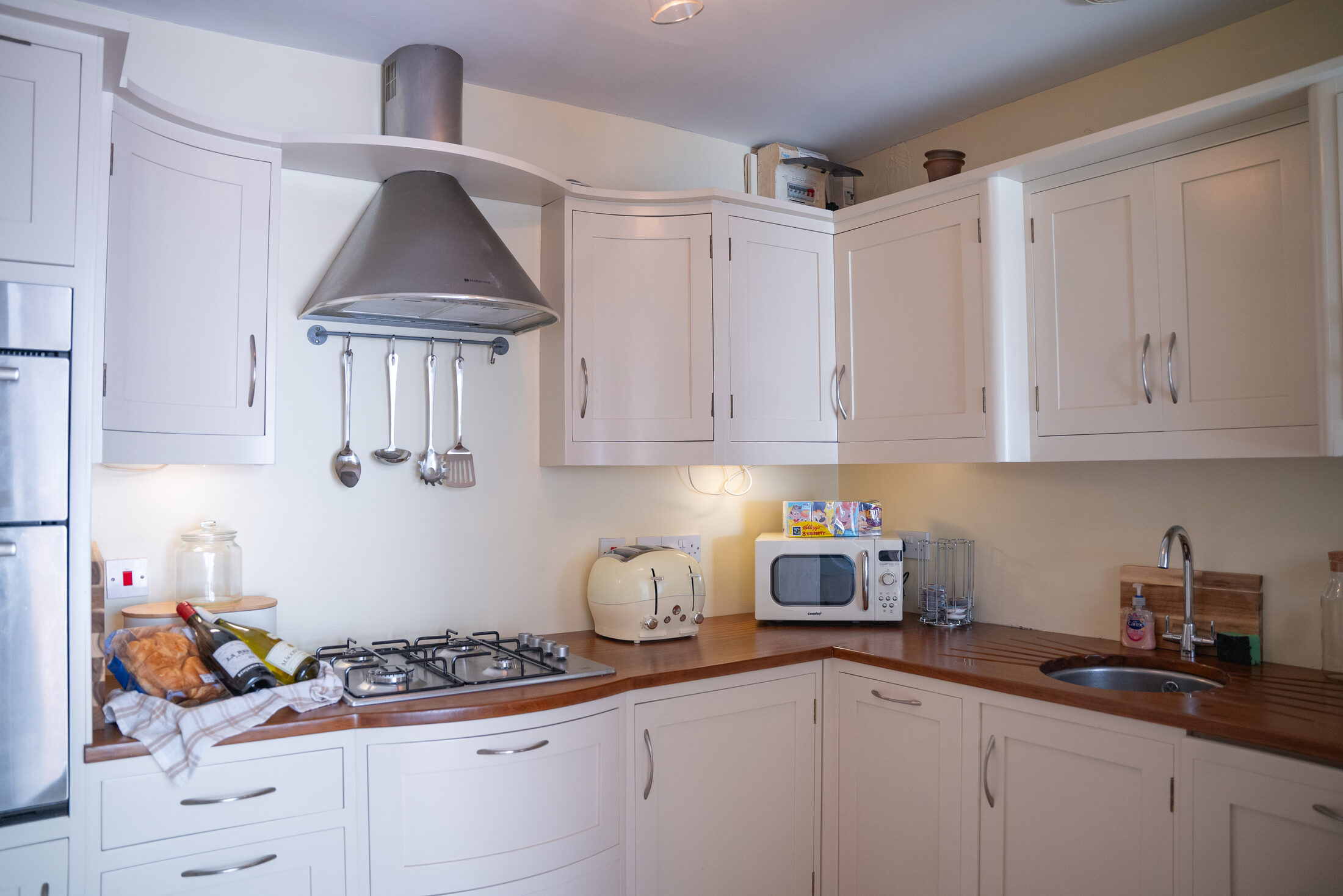 The kitchen in the cottage at The Briers, with a gas hob and wooden worktops