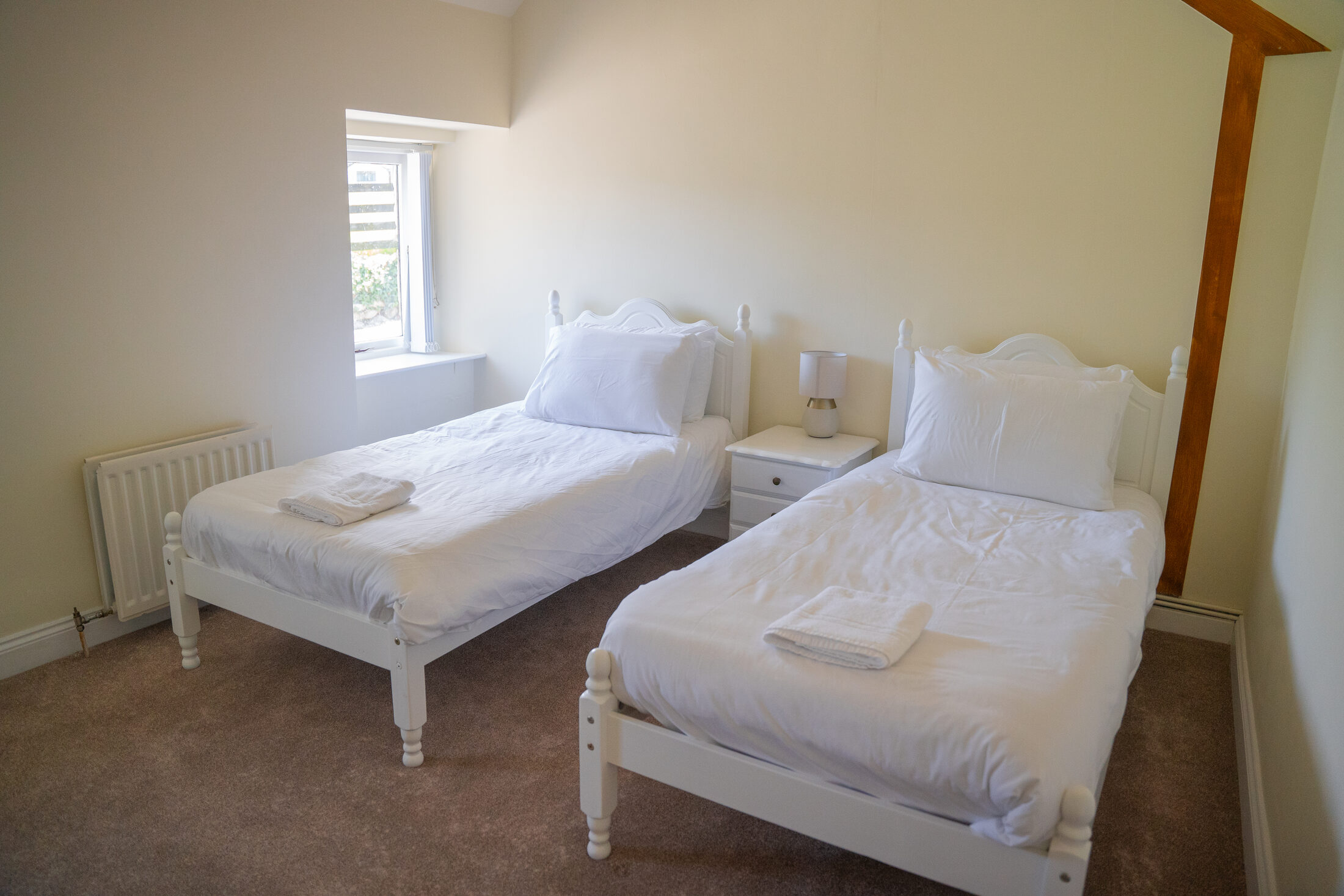 The twin bedroom in the cottage at The Briers, with two single beds