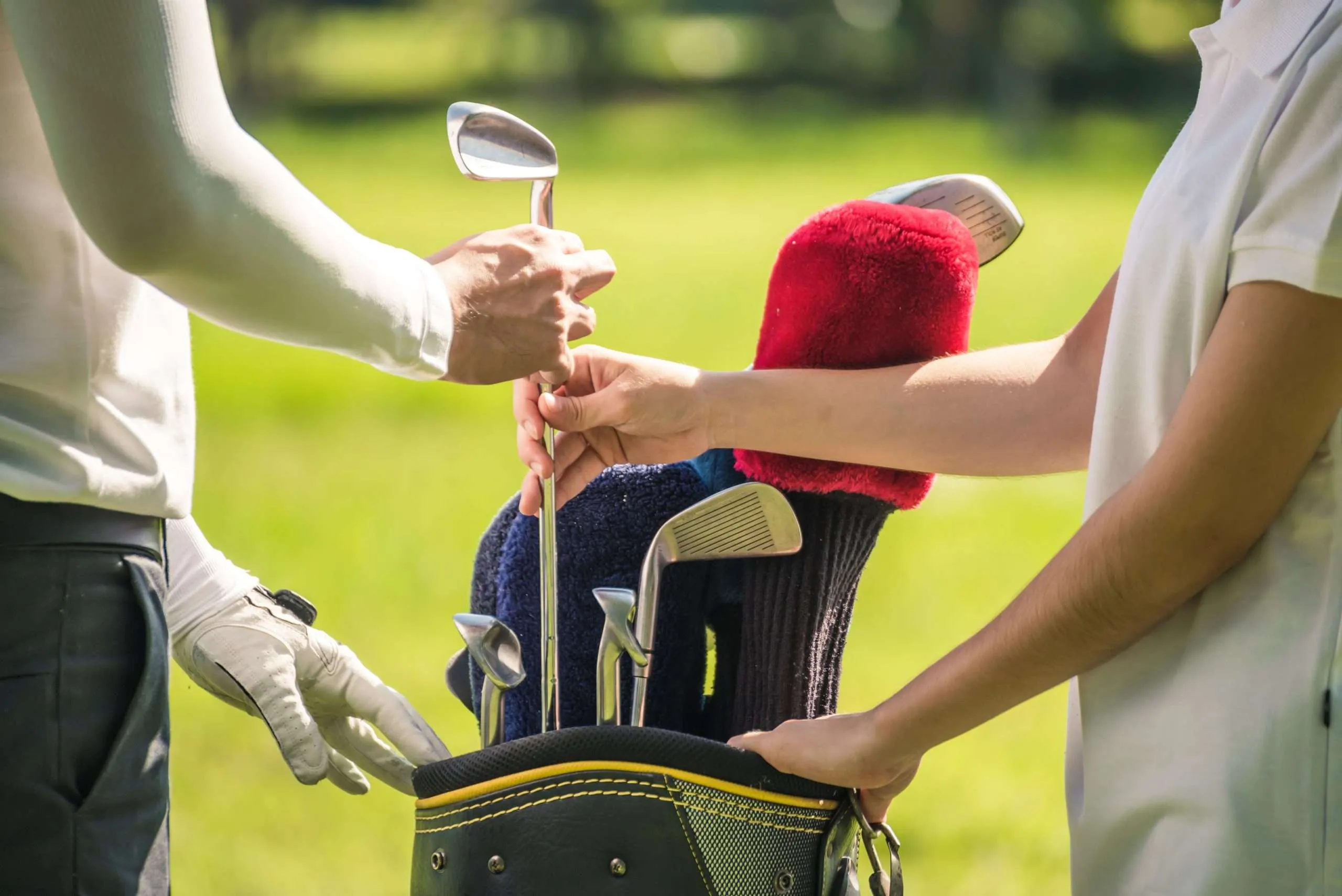 A golf group meeting their caddies on the first tee