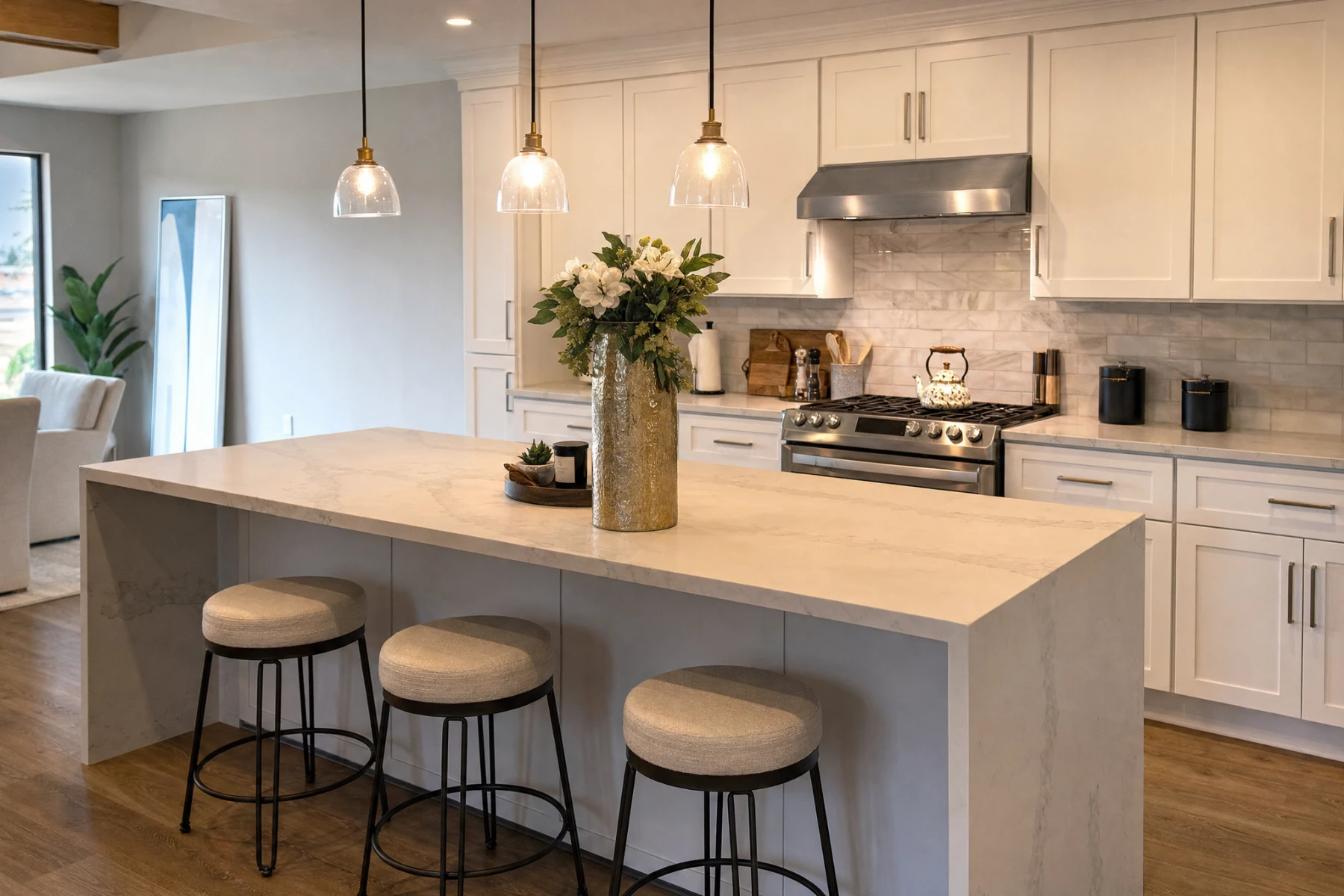 Quartz waterfall island and white shaker cabinets in a remodeled Cypress, Texas kitchen