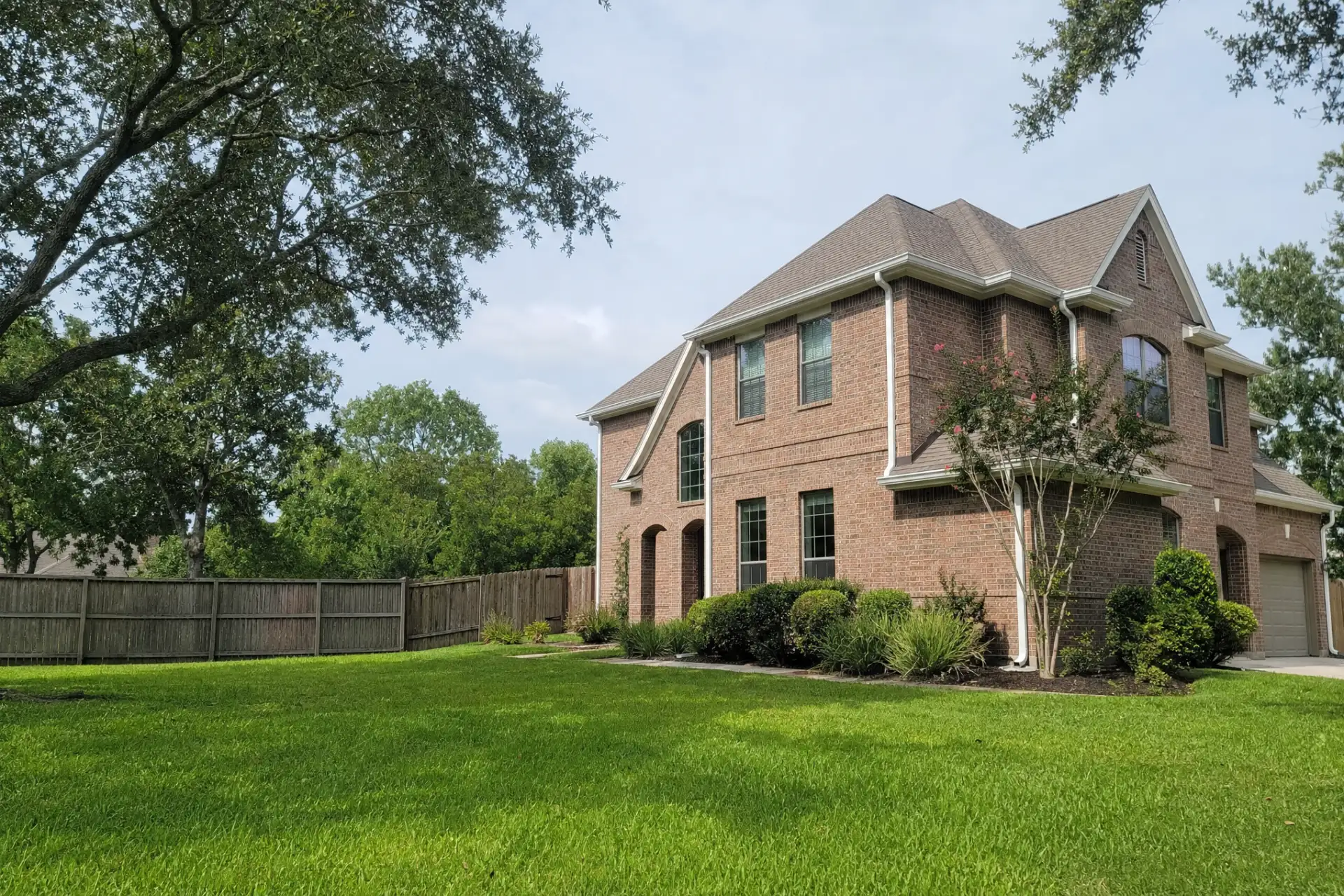 Complete seamless gutter system on a two story brick home in Cypress, Texas