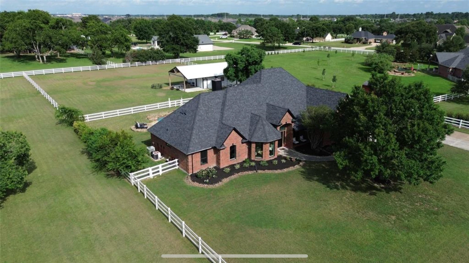 Aerial view of a Houston area acreage home with a new dark architectural shingle roof by AllPhase