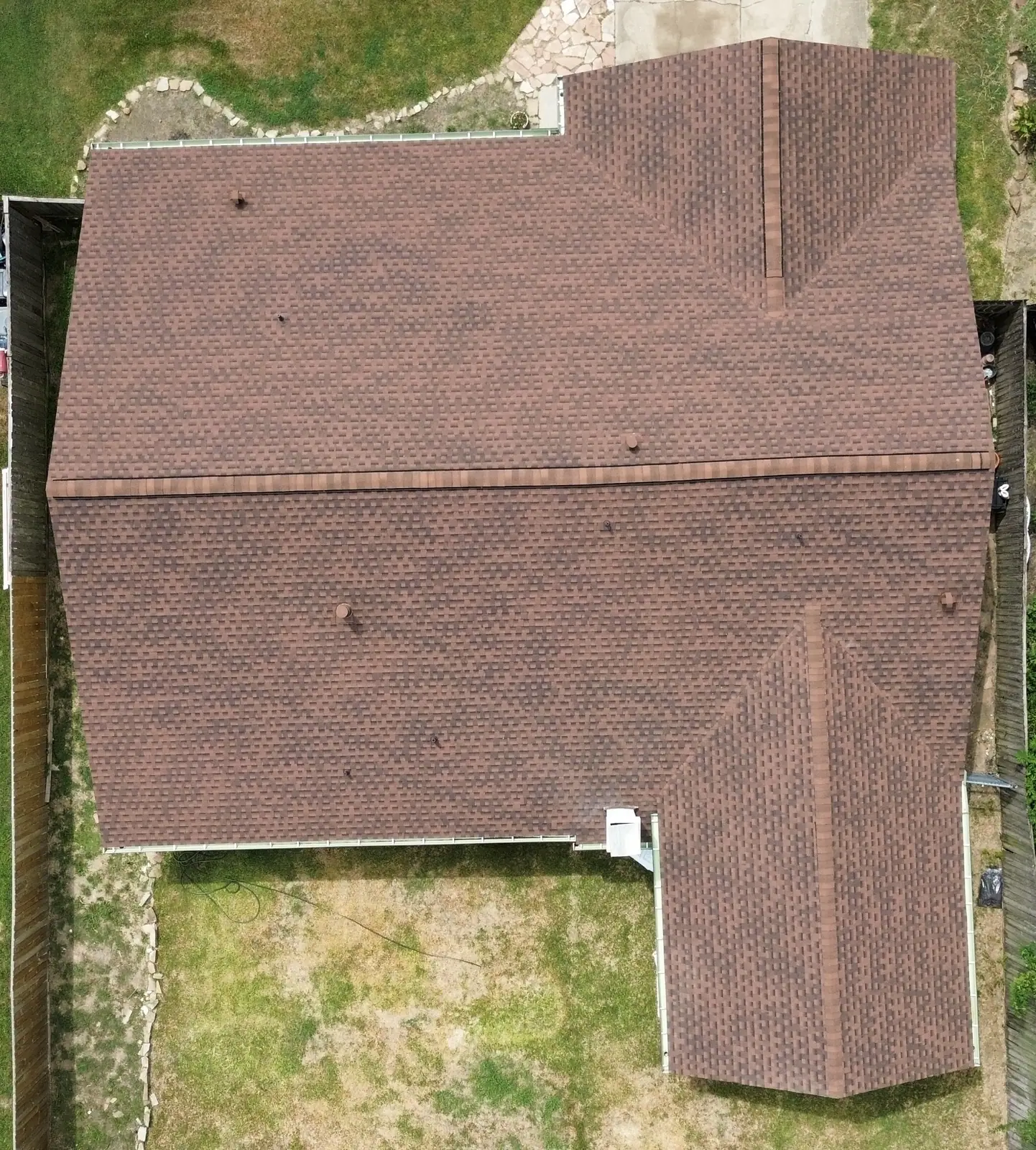 Top down drone survey of a weathered brown shingle roof on a Houston area home