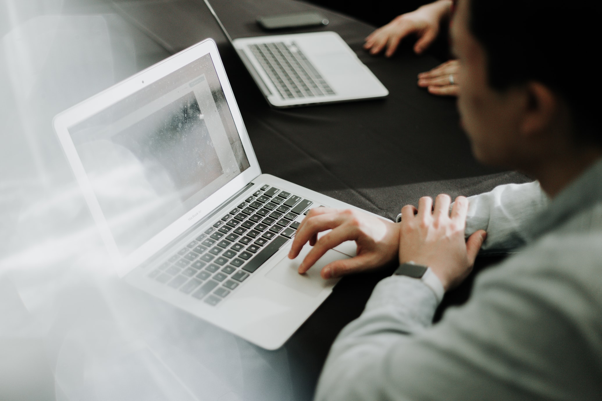 man making email database on laptop