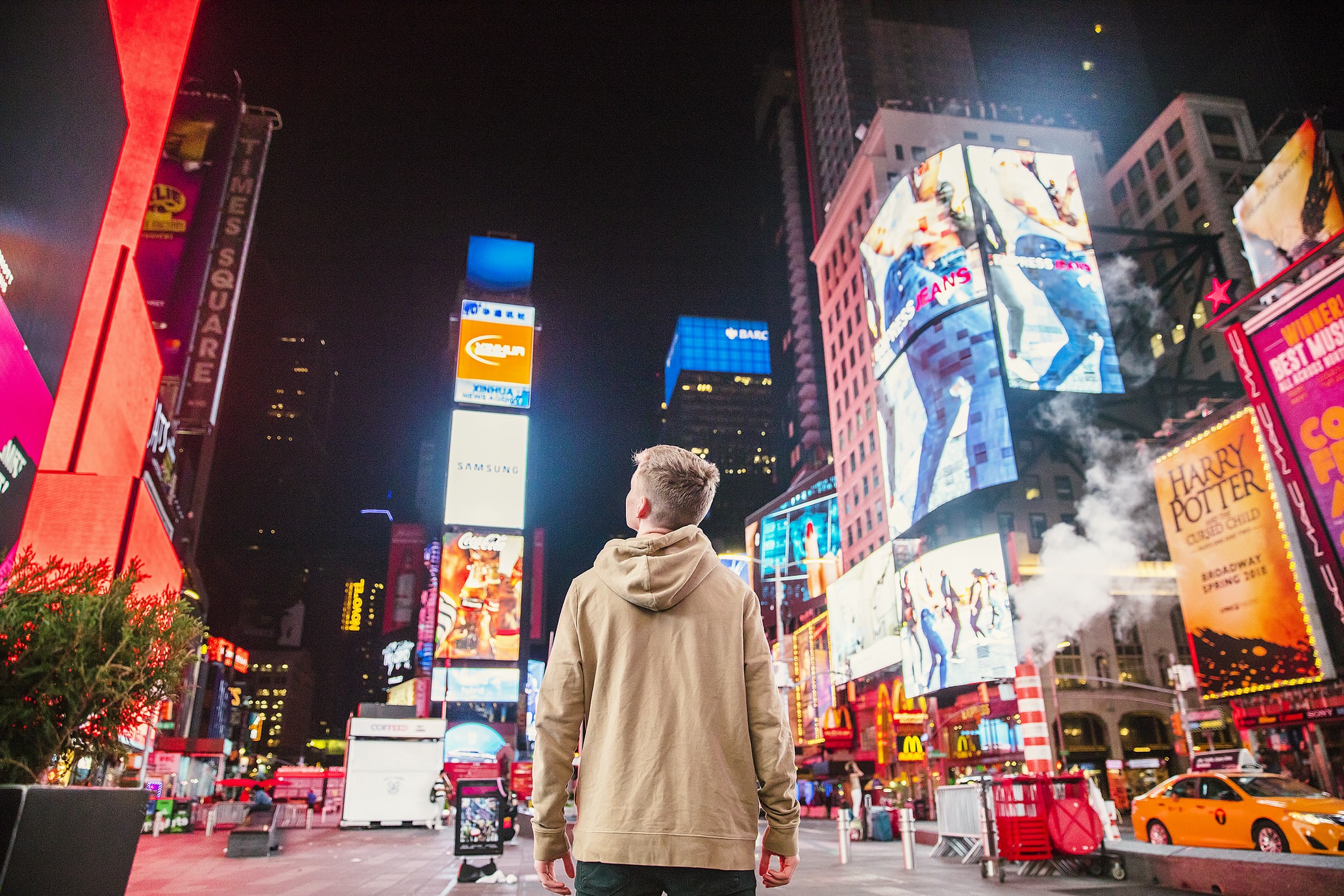 man looking at powerful advertising on busy street 