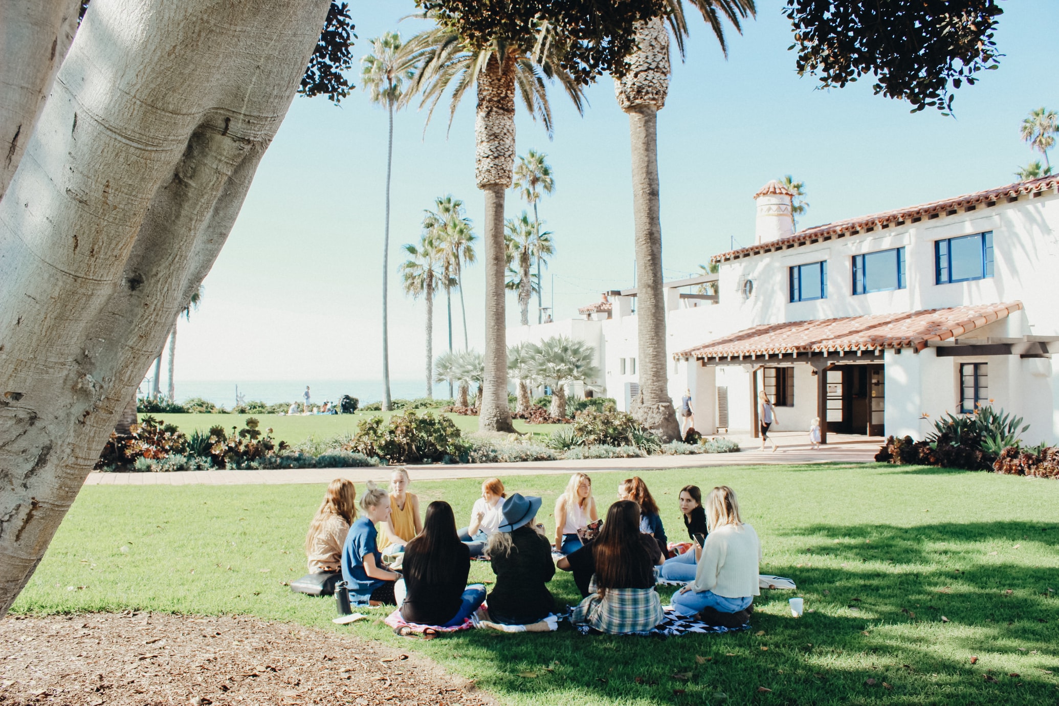 community sitting in circle outside