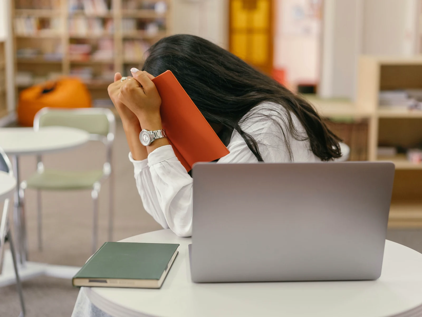 Embarrassed by my website: a person hiding their face behind a book
