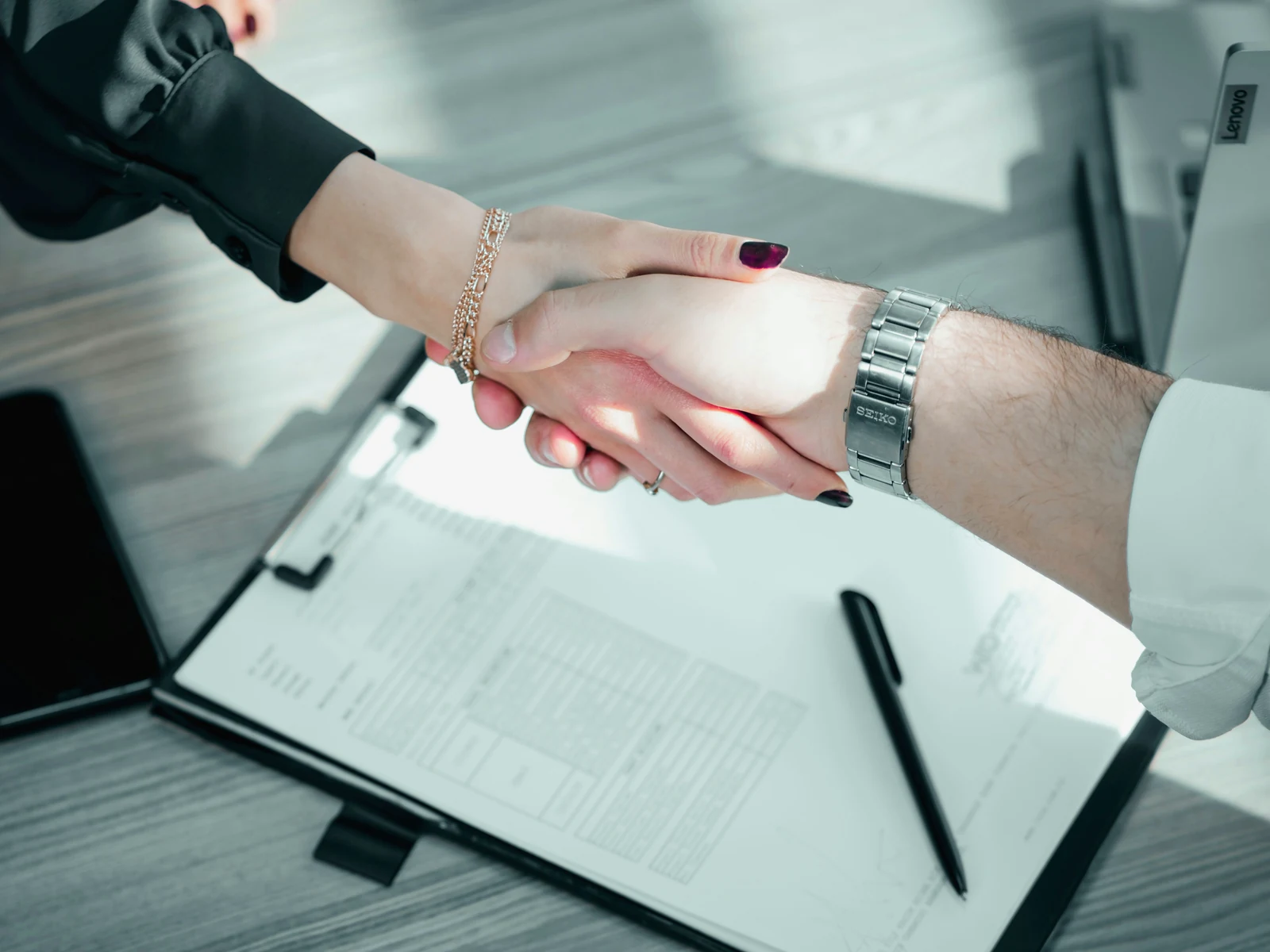 How to structure website for conversions: two people shaking hands