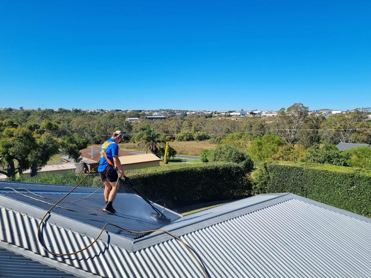Posh Wash team pressure cleaning a tin roof in Brisbane