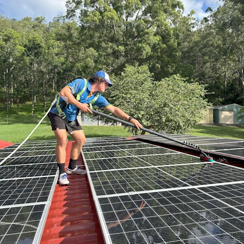 Cleaning solar panels on a Brisbane roof with a deionised water system