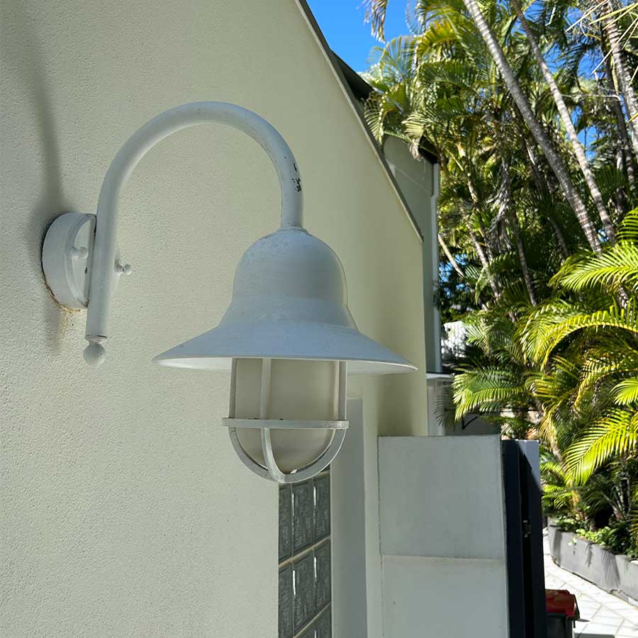 The same house lamp and wall after Posh Wash pressure cleaning