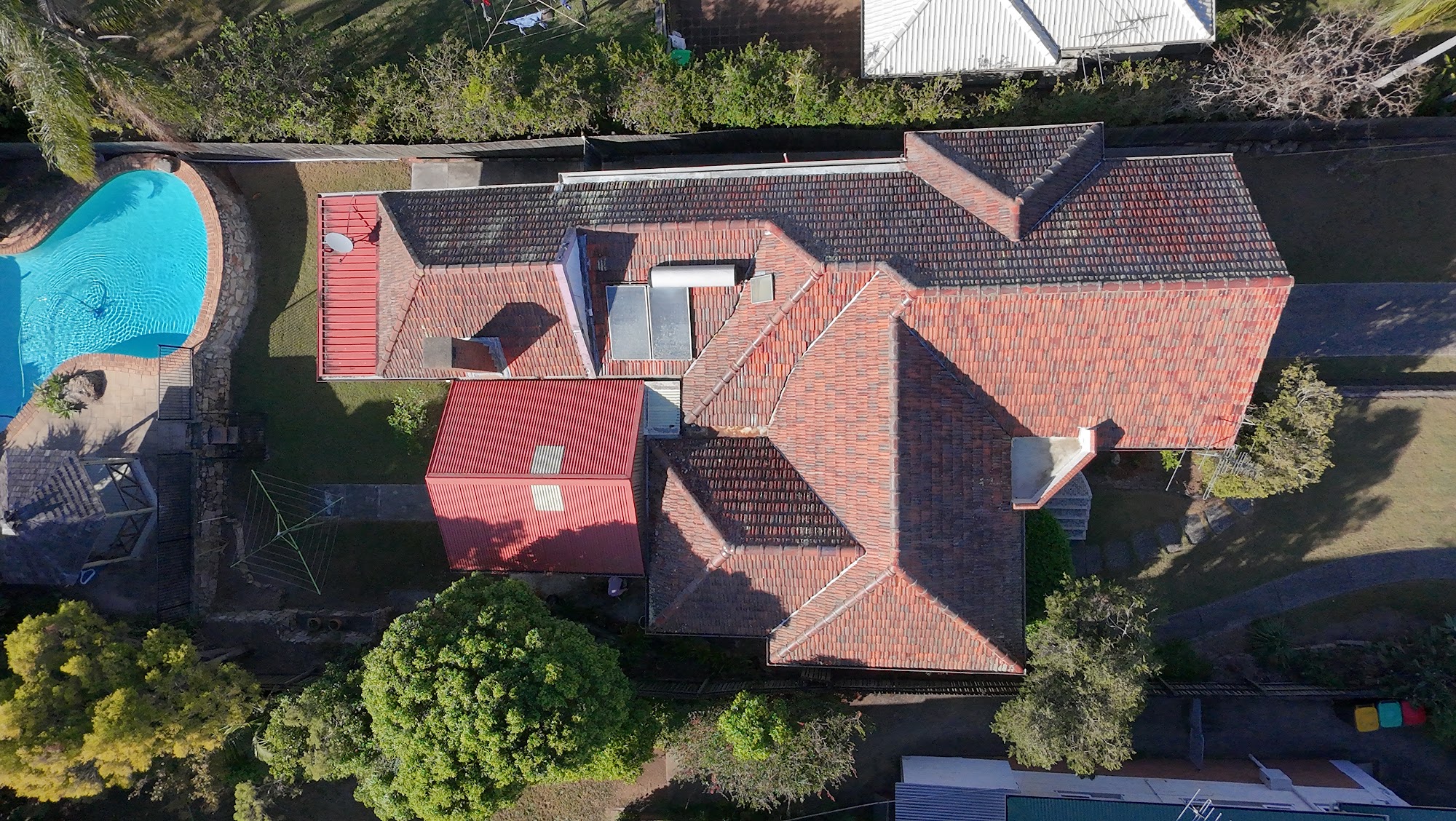 Drone view of a heavily soiled tile roof in Moorooka before cleaning