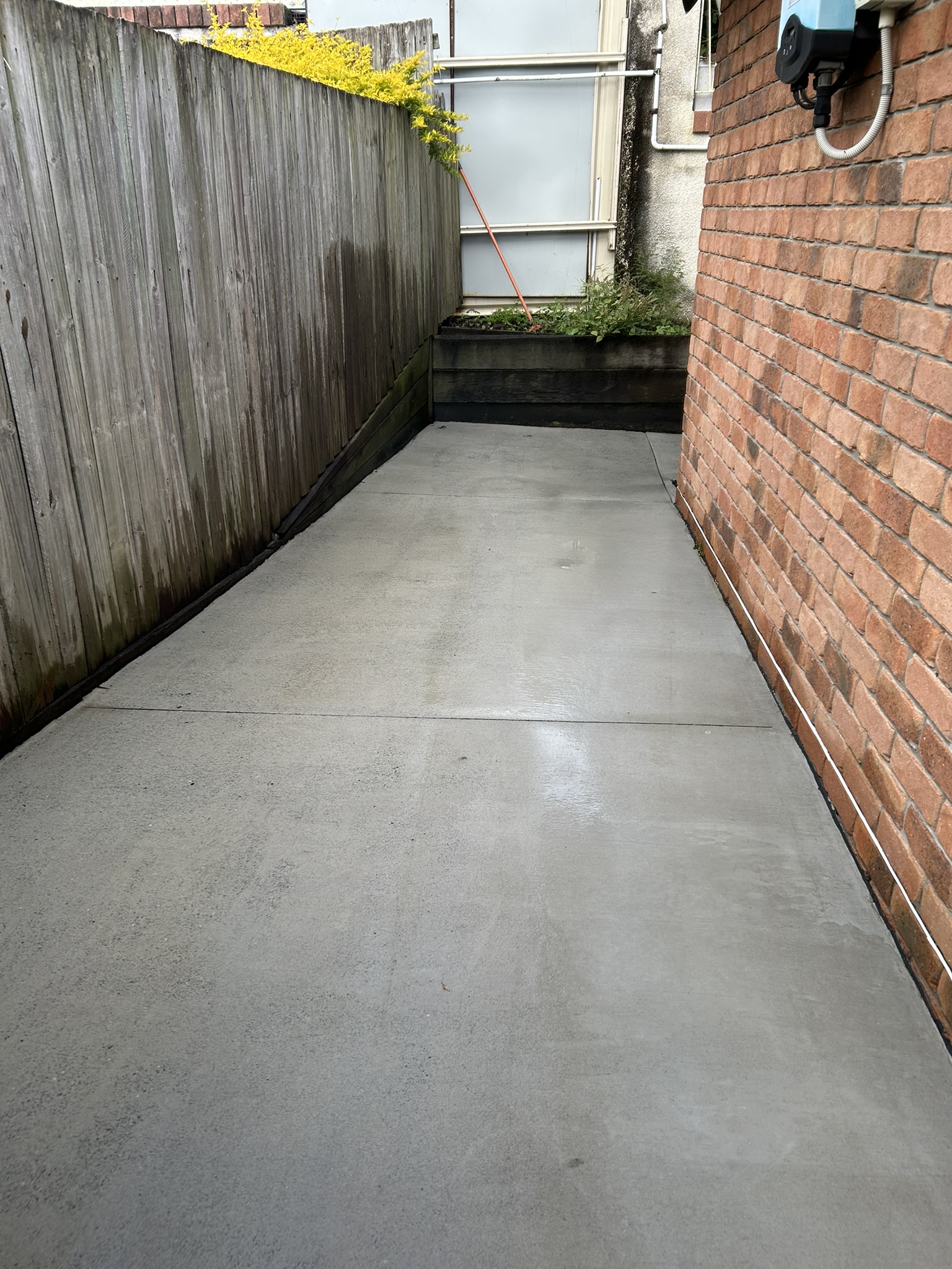 The same concrete driveway after pressure cleaning