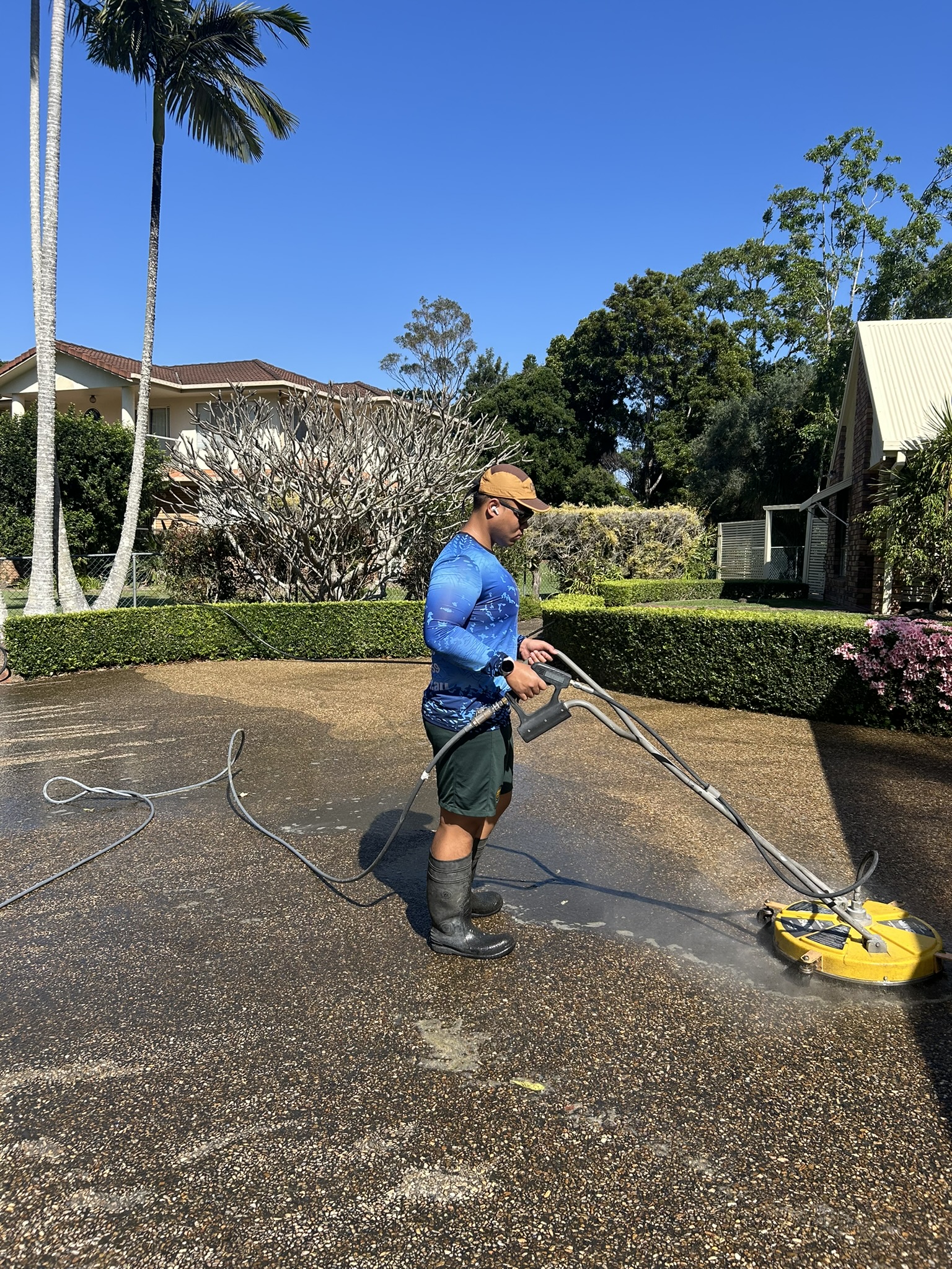 A Posh Wash team member cleaning a roof in Brisbane