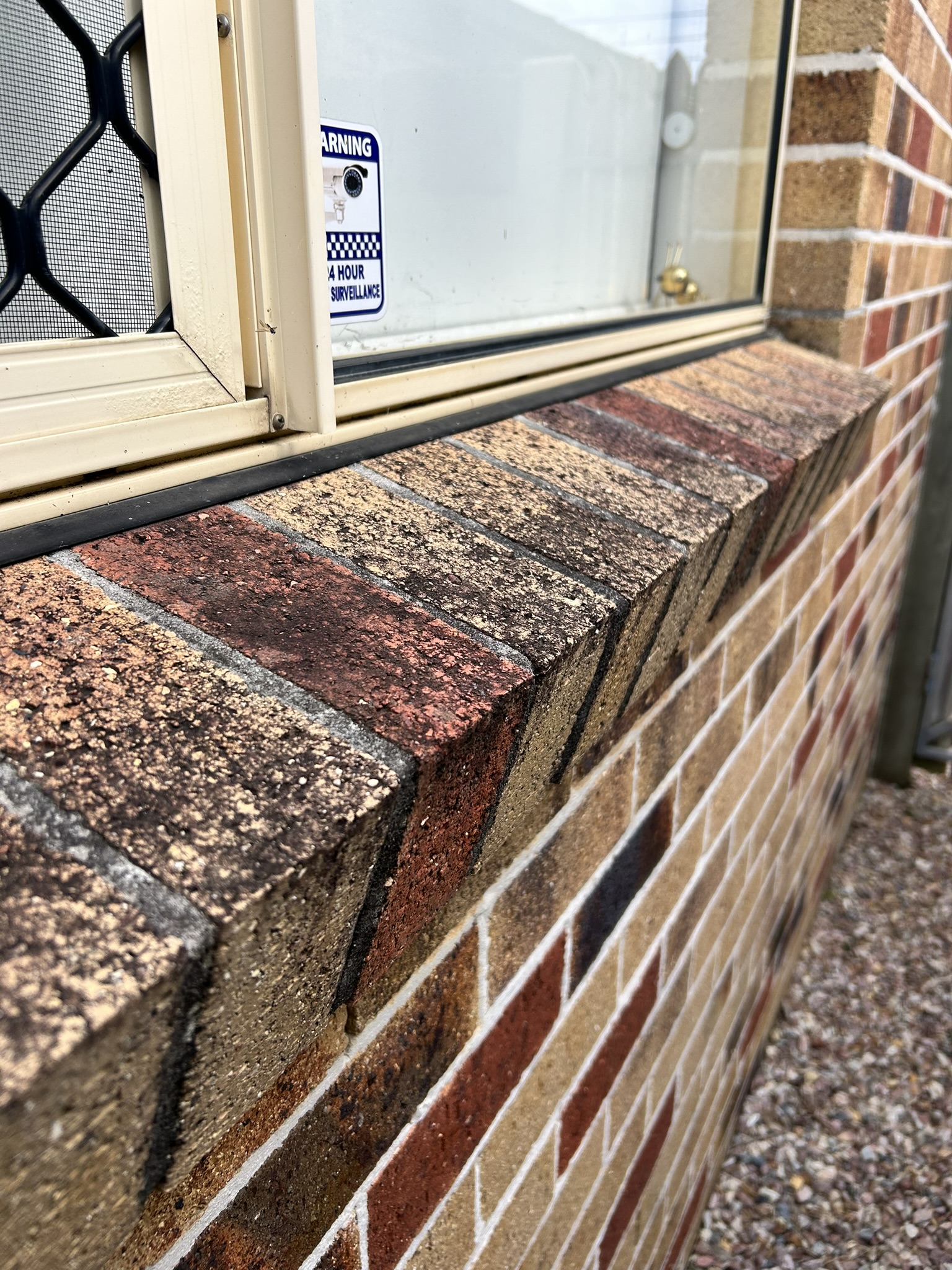 A window ledge and frame thick with grime before cleaning