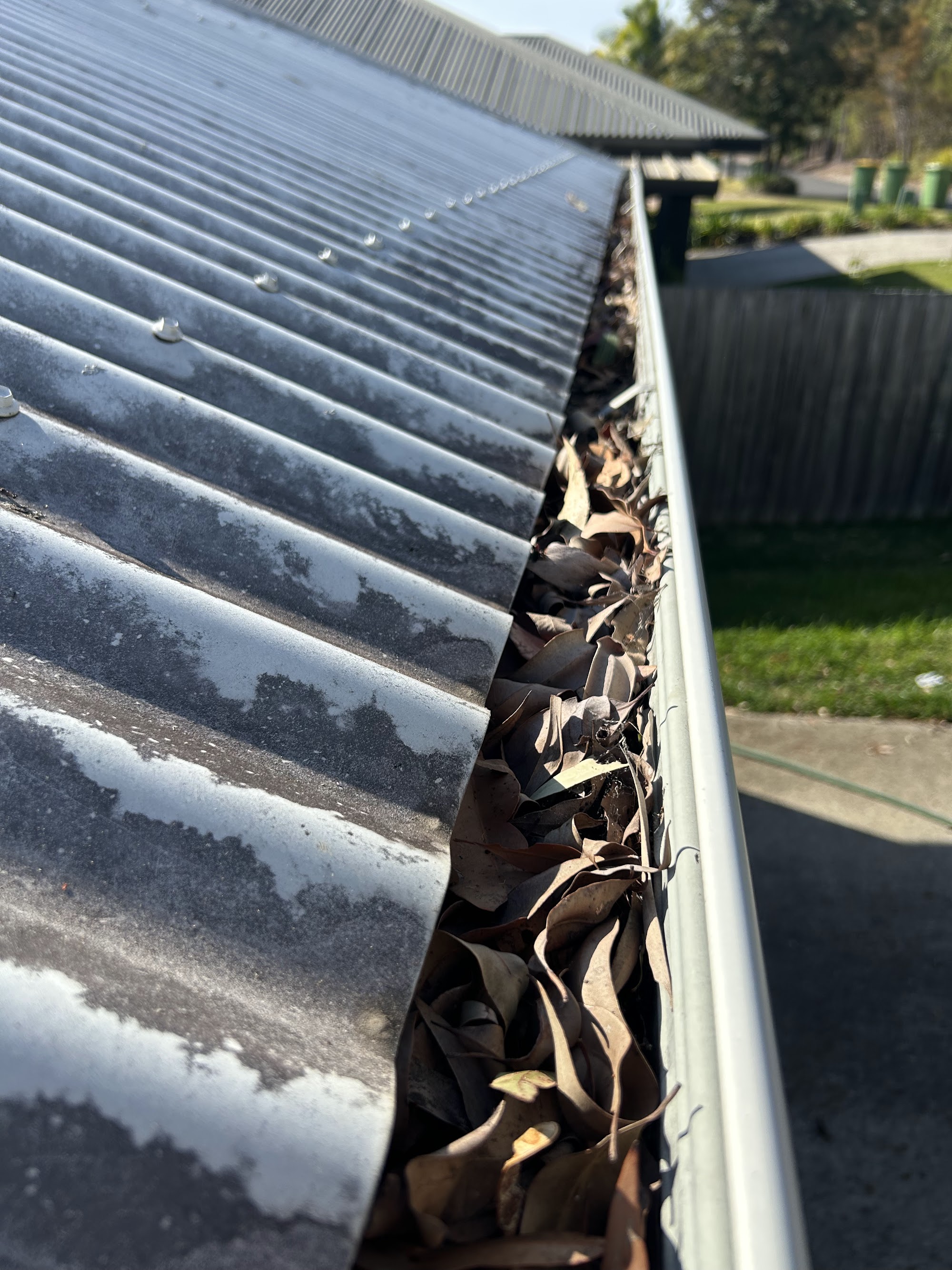 A second blocked gutter full of debris before clearing