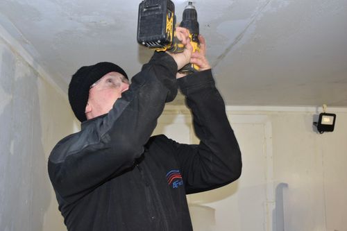 4Facilities engineer drilling fixings during a cold-room installation