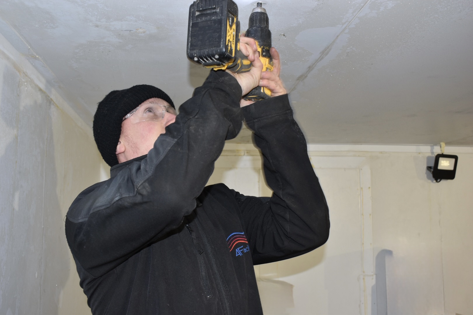 4Facilities engineer drilling fixings during a cold-room installation