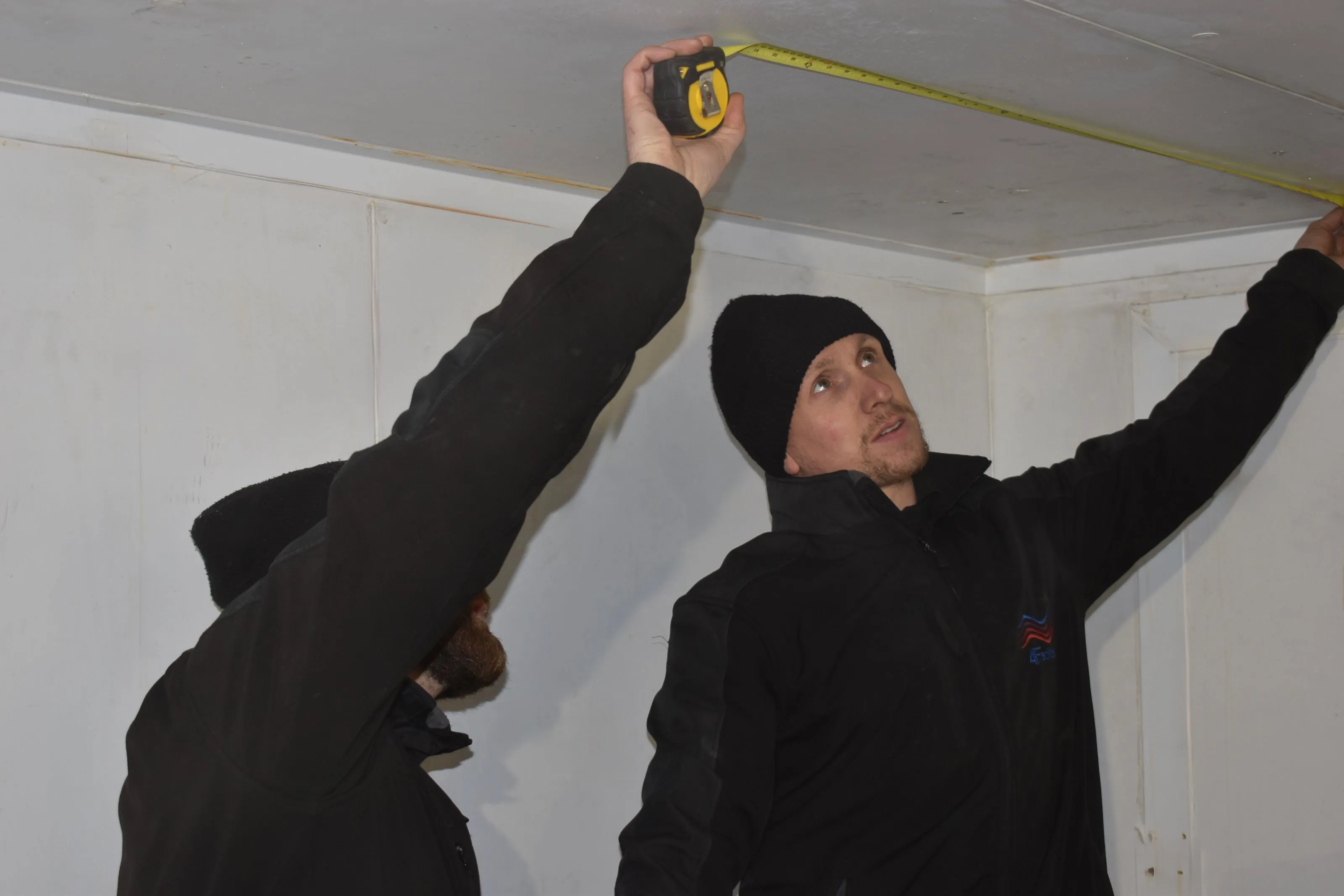 4Facilities engineers measuring inside a cold room during installation work