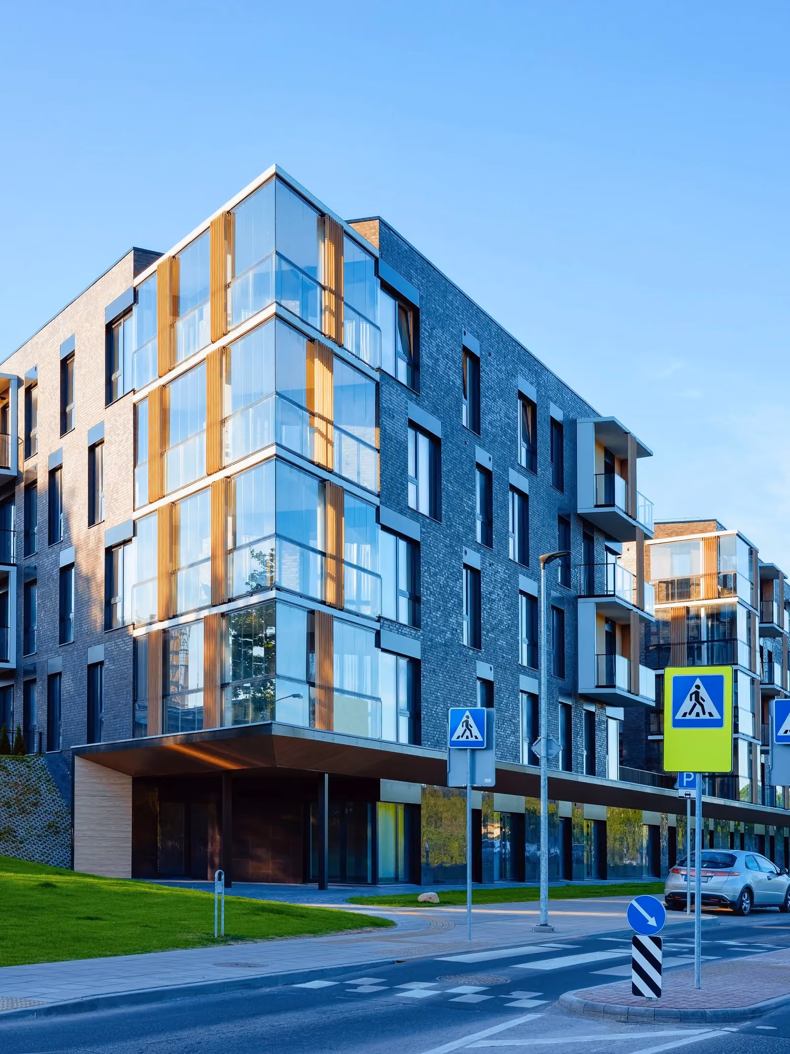 Modern glass and brick apartment block on a street corner