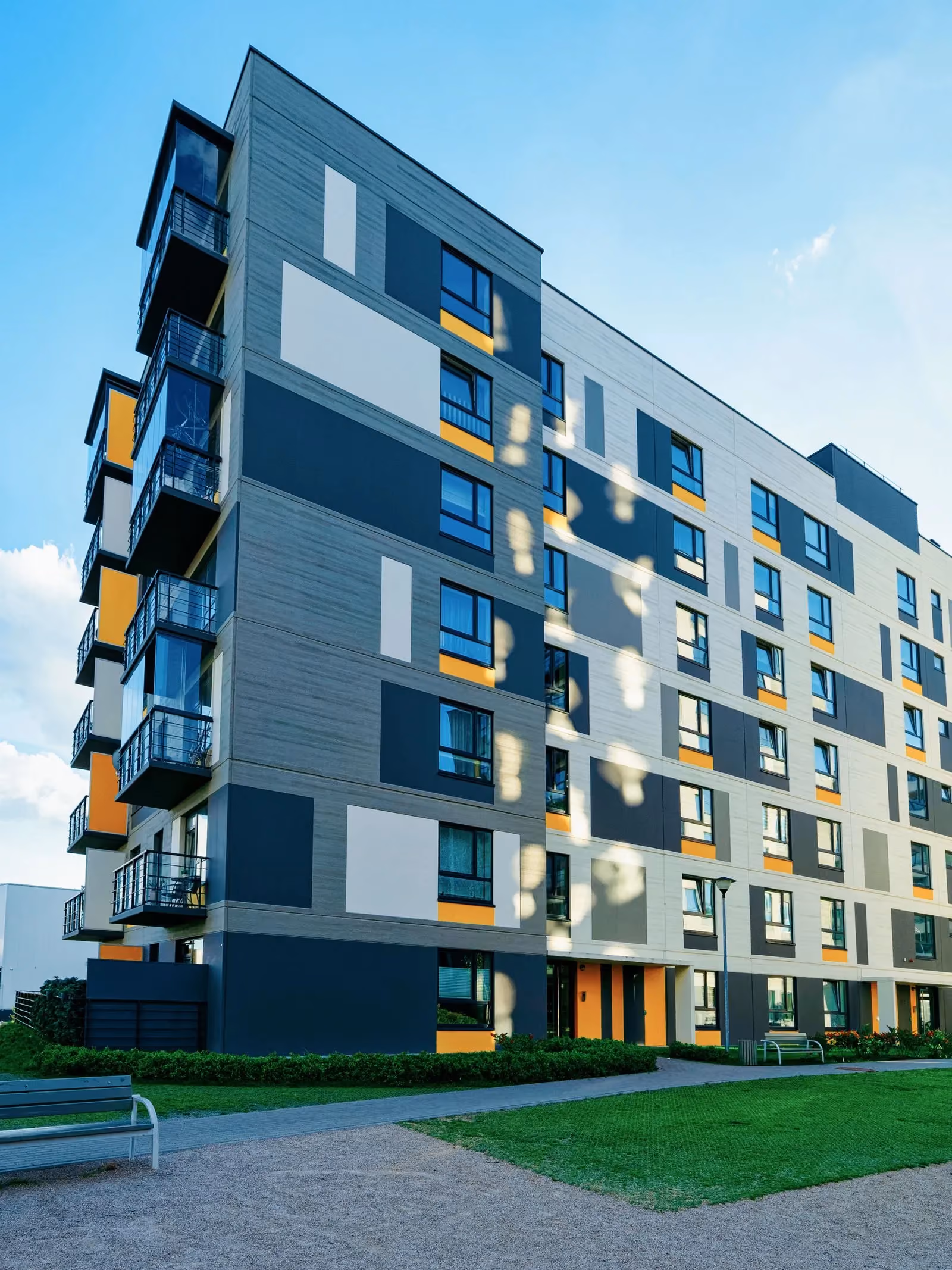 Contemporary apartment block with grey and amber panels