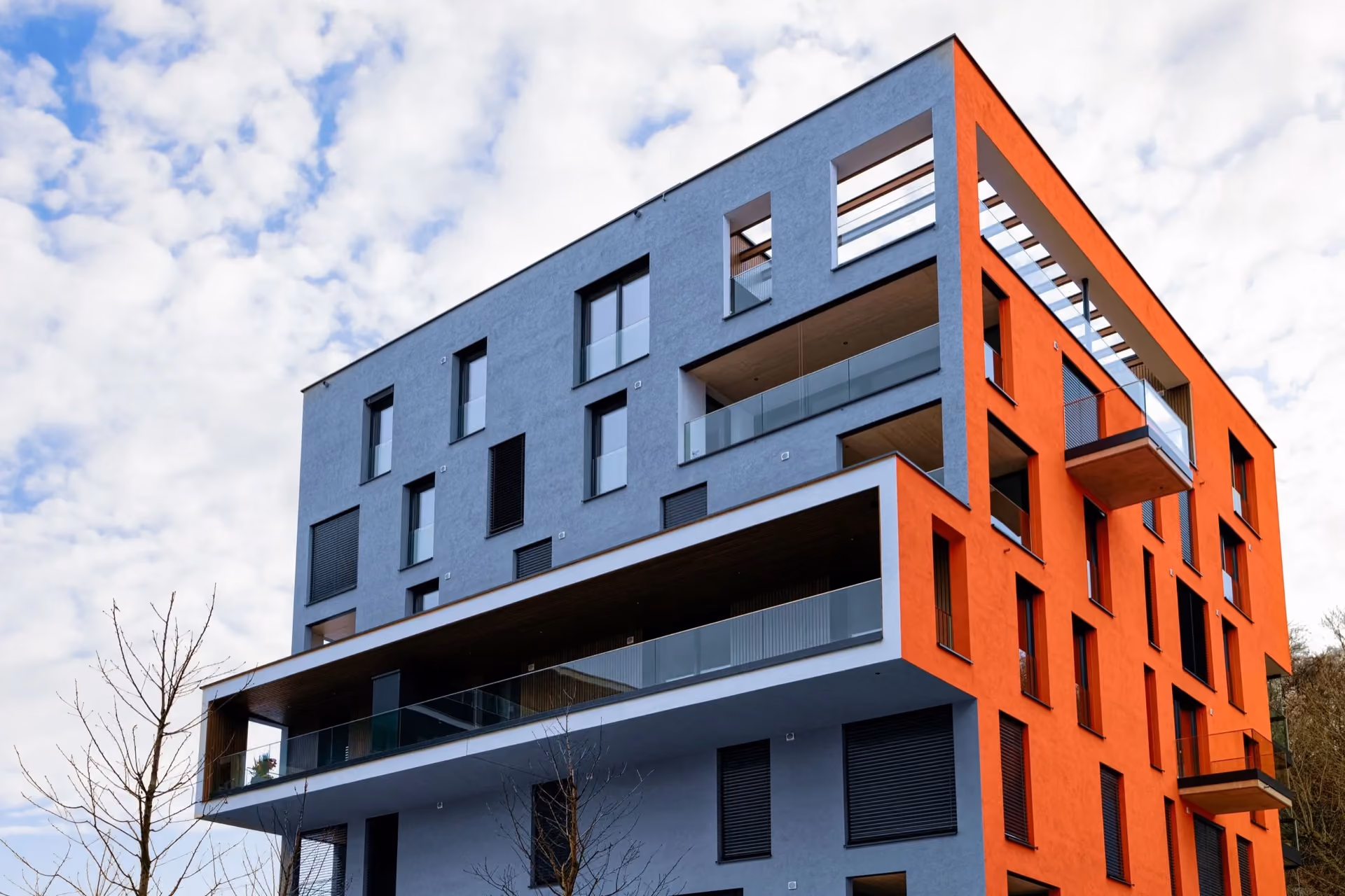 Colourful modern apartment blocks with balconies around a landscaped courtyard