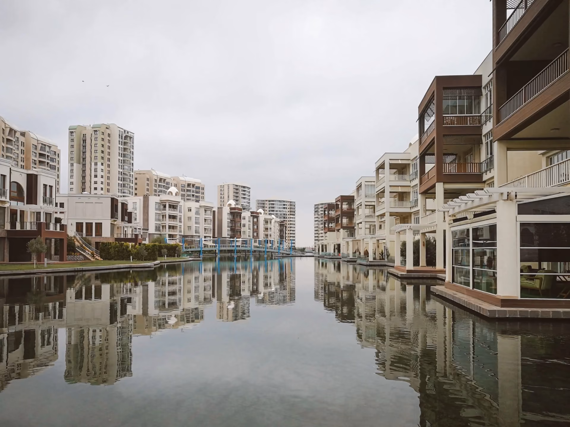 Waterside apartment buildings reflected in a still canal