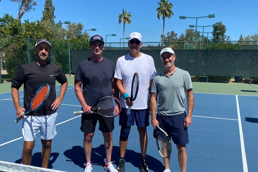 Four players with racquets on court at the 2024 Member/Guest tournament.