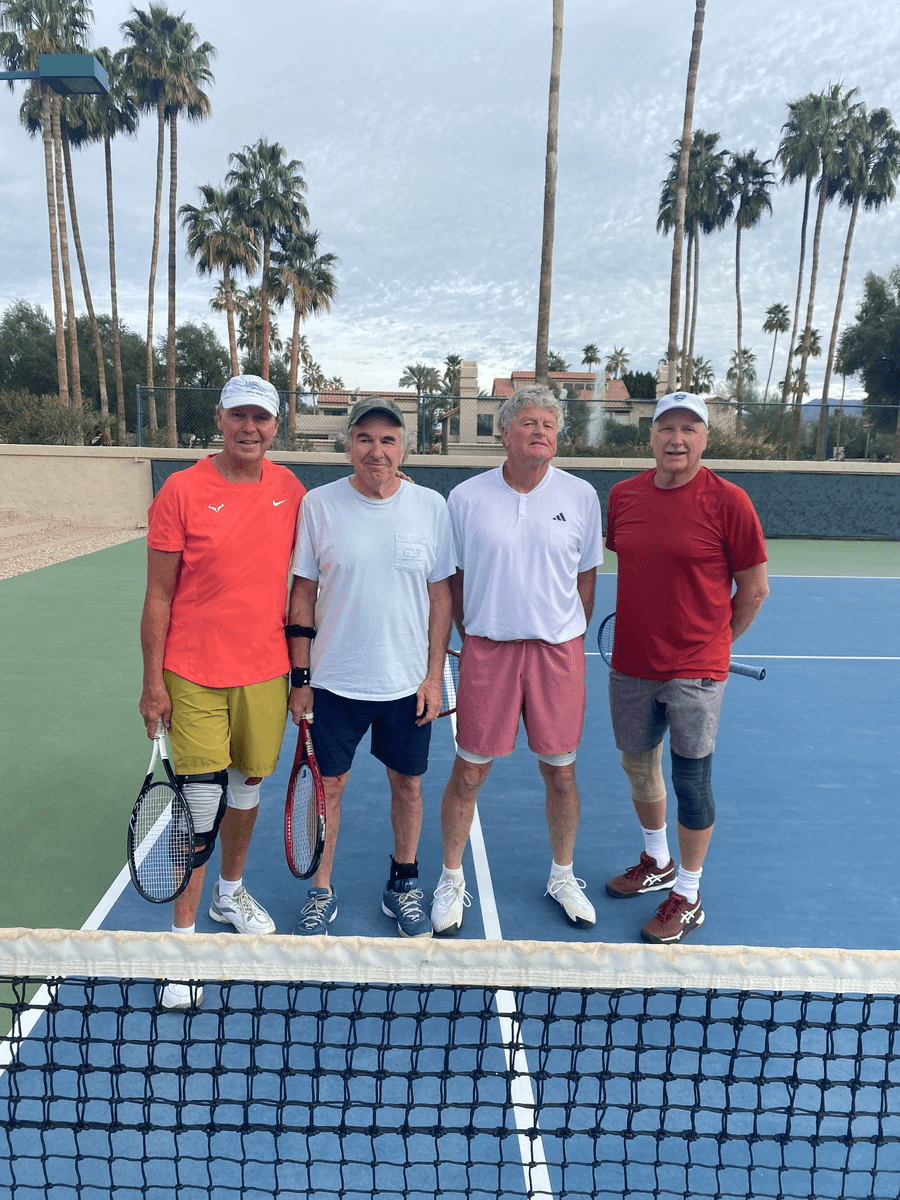 Four players behind the net at the 2024 over-60 doubles final.