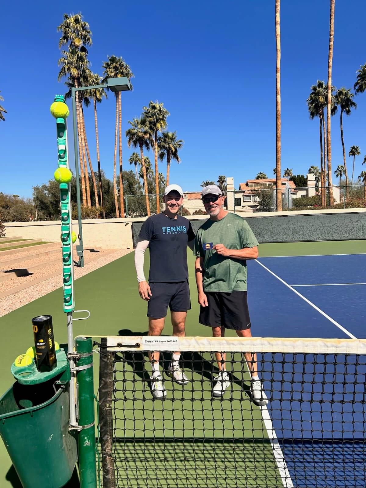 Two players standing behind the net at the 2025 doubles championship.