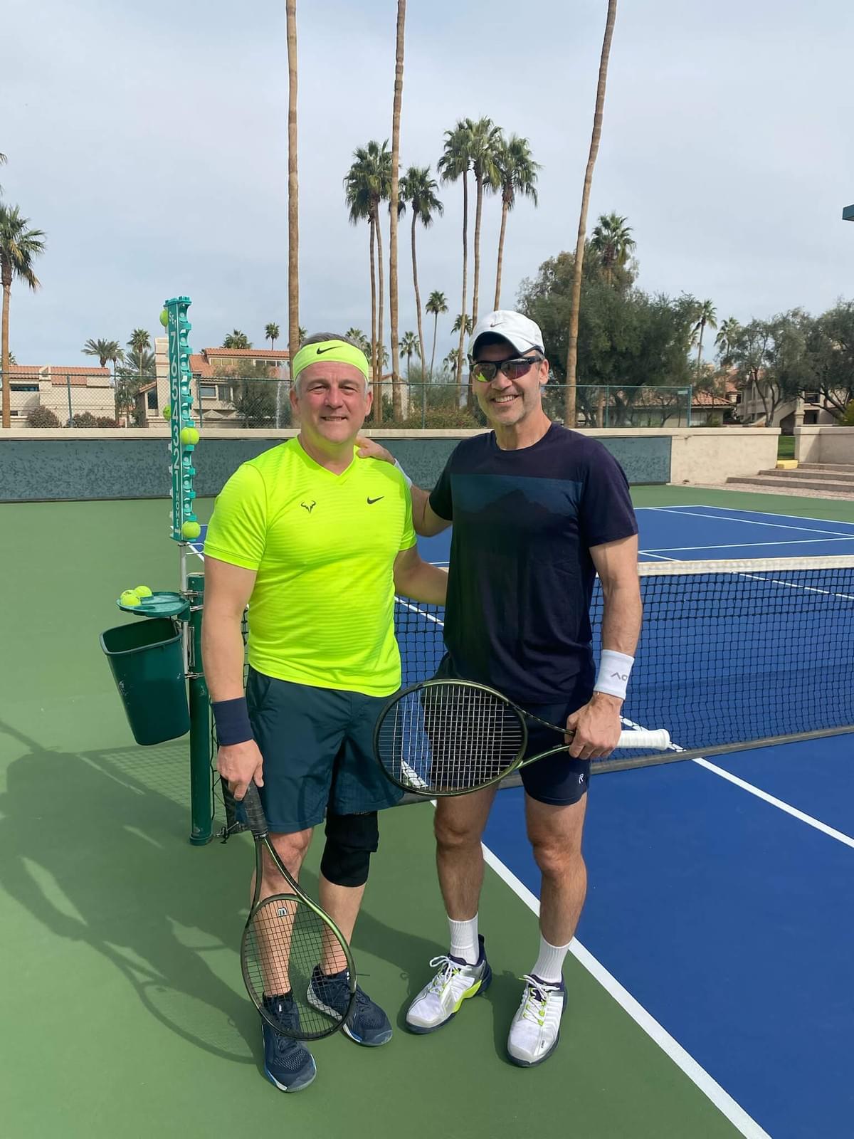 Two players with racquets beside the net at the 2025 singles championship.
