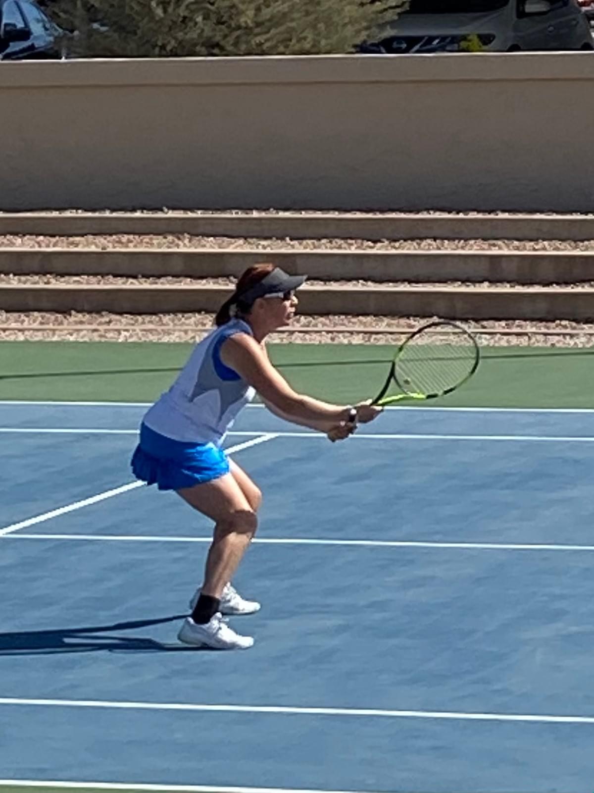 A player preparing a two-handed return during the 2022 ladies open final.